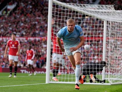Manchester City's Erling Haaland celebrates after scoring his sides first goal during the English Premier League soccer match against Manchester United in Manchester, England, Sunday. (AP)