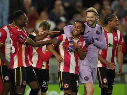 Brentford players celebrate after the Premier League  match between Brentford and Chelsea in London, England yesterday.