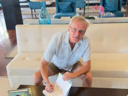 Author Simon Firth signs copies of his book, ‘Bond in Jamaica’.