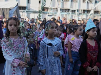 Palestinian children line up on the first day of the new academic year at an UN-run school in Nuseirat, central Gaza Strip.