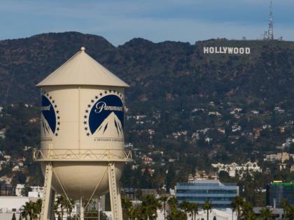 The Paramount Pictures water tower is seen in Los Angeles, December 18, 2025, with the Hollywood sign in the distance. 