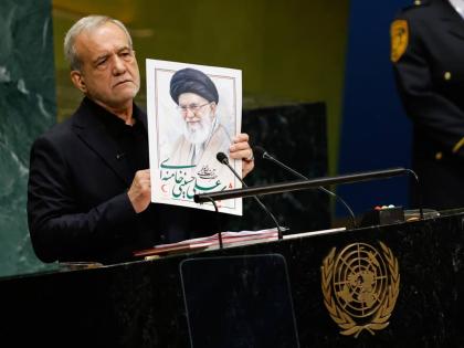 Iran’s President Masoud Pezeshkian holds an image of late Iranian Supreme Leader Ayatollah Ali Khamenei during the 81st session of the United Nations General Assembly at United Nations headquarters, Wednesday.