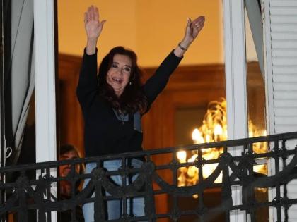 Former Argentine President Cristina Fernandez, who is serving a prison sentence under house arrest for corruption, waves from the balcony of her home during a rally in Buenos Aires, Argentina, September 1.