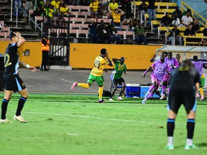 Renaldo Cephas (centre) of Jamaica celebrates after scoring the winner in the Jamaica versus  Guatemala Concacaf Nations League match at the National Stadium last night.