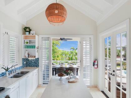 
An island kitchen opens fully to both indoor and outdoor living spaces.