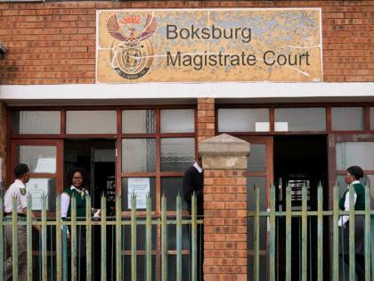 Court workers are seen at the entrance of the Boksburg Magistrate Court, east of Johannesburg, South Africa last Monday, where suspects appeared in connection with one of a series of killings of women near Johannesburg. 