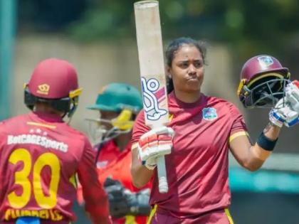 
West Indies women’s batter and captain, Hayley Matthews (right), celebrates scoring a century in the first One-Day International against Zimabwe in that country on Thursday.