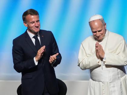 Pope Leo XIV is congratulated by French President Emmanuel Macron (left) after his speech at the ‘At the Roots of Europe for Peace and Unity’ meeting in Metz, France, on Monday.