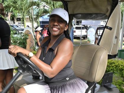 Revenue Manager at Pepsi-Cola Anecka Clarke turns the golf cart into the perfect photo op.