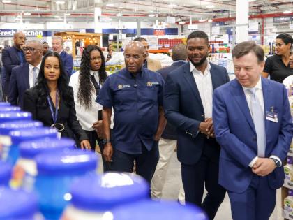 Rodrigo Calvo (foreground), executive vice-president, real estate, PriceSmart leads a tour of the newly opened PriceSmart location in Montego Bay with Industry, Investment and Commerce Minister Senator Aubyn Hill (centre) on Tuesday. Also pictured are Mayo
