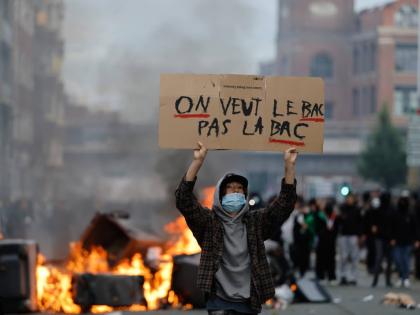 A student holds a board reading, ‘we want the BAC (High School Diploma) Not the BAC (Anti-criminality units)’ during a protest to demand more resources at school, in Lille, France, Thursday.