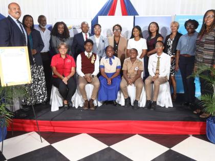 Group photo of the representatives of the signatory organisations and school children at the launch of “Weight a Bit… Turning the Tide on Childhood Obesity in Jamaica” on September 30.