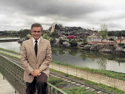 FILE - Television evangelist Jim Bakker poses in front of the Water Park in Columbia, SC, one of the attractions at his Heritage USA, March 19, 1987. (AP Photo/Lou Krasky, File)