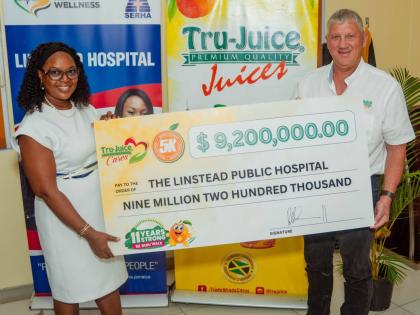 Peter McConnell (right), managing director of Trade Winds Citrus Limited, hands over the Tru-Juice 5K Run/Walk donation to Camile Wallen-Panton, CEO of Linstead Public Hospital, at a ceremony held at the hospital on Monday.