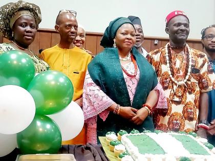 Preparing to cut the cake marking Nigeria's 66th Independence anniversary are (back row, from left) Stephanya Odiase (partially hidden), Adebowale Adeite and Fisayo Otokolo; and (front row, from left) Omolade Iyantan, first secretary at the Nigerian High C