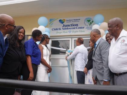 Health and Wellness Minister Dr Christopher Tufton (centre) cuts the ribbon to open the Child and Adolescent Health Centre at the Junction Health Centre in St Elizabeth on Thursday. Sharing in the occasion (from left) are Sean Brissett, parish manager for 