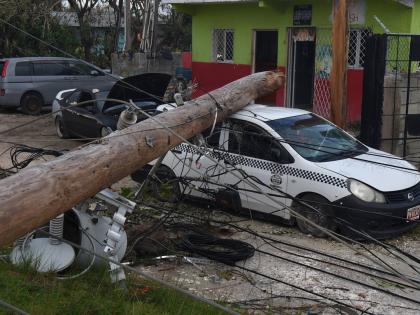 A utility pole broke and fell on a parked car in Salt Marsh, Trelawny, during the passage of Hurricane Melissa last October.