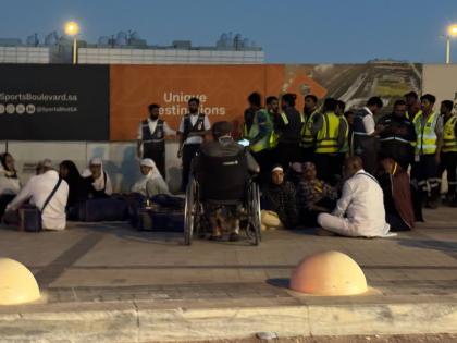 People gather outside a metro station on the road to King Khalid International Airport in Riyadh, Saudi Arabia