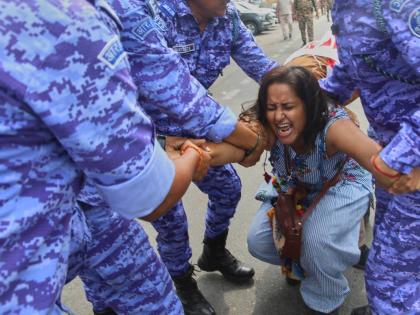Police detain a protester during a demonstration demanding the resignation of Chief Election Commissioner Gyanesh Kumar during a protest in New Delhi.