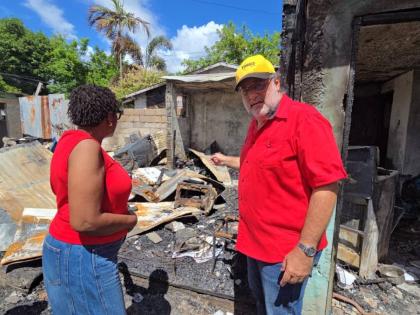 Opposition Leader Mark Golding (right) and St Andrew South West Member of Parliament Dr Angela Brown Burke on a tour of Kidd Lane off Spanish Town Road, St Andrew, on Monday. 