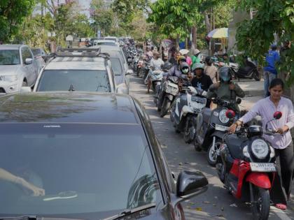 People queue at a gas station amid a fuel shortage in Denpasar, Bali, Indonesia, Wednesday.