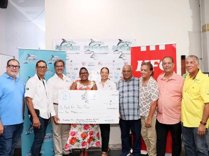 Charles Ross (third left), president and chief executive officer of Sterling Asset Management, title sponsor of the tournament, presents a cheque for $2 million to Marsha Burrell-Rose (fourth left), development and marketing manager at Food For The Poor Ja