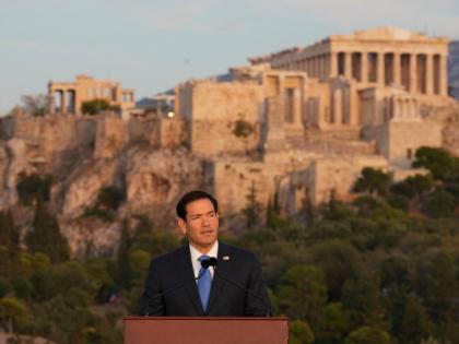 US Secretary of State Marco Rubio speaks at the Pnyx hill, where ancient Athenians held democratic assemblies, with the ancient Parthenon temple atop the Acropolis in the background, in Athens, Wednesday, October 7, 2026. (AP Photo/Mark Schiefelbein, Pool)