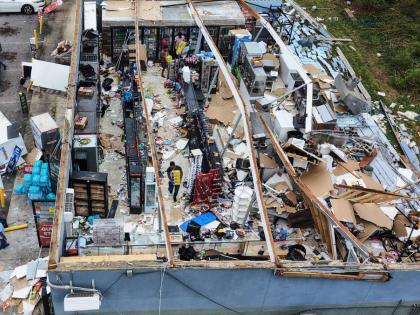 People salvage the contents of their destroyed mini mart in the aftermath of Hurricane Isaias in Milton, Florida, Saturday, October 10, 2026.