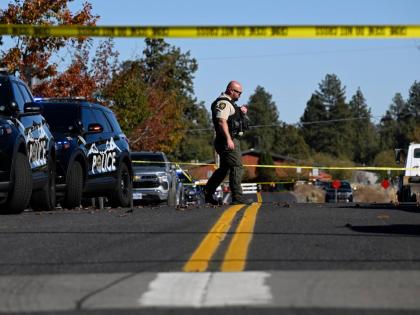 A sheriff's deputy walks outside Silver Rail Elementary school, where a shooting took place, on Thursday, Oct. 15, 2026 in Bend, Ore. (AP Photo/Joe Kline)