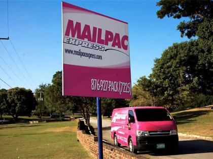  A sign and delivery van branded in Mailpac colours. 