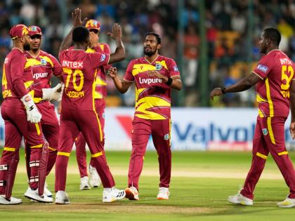 West Indies’ Keemo Paul (second right) celebrates with teammates the dismissal of India’s Abhishek Sharma during the fifth T20 International cricket match against India in Bengaluru, India.