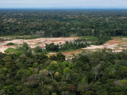 Deforestation from illegal mining surrounds the Malinowski River in the Tambopata National Reserve in Puerto Maldonado, Peru.