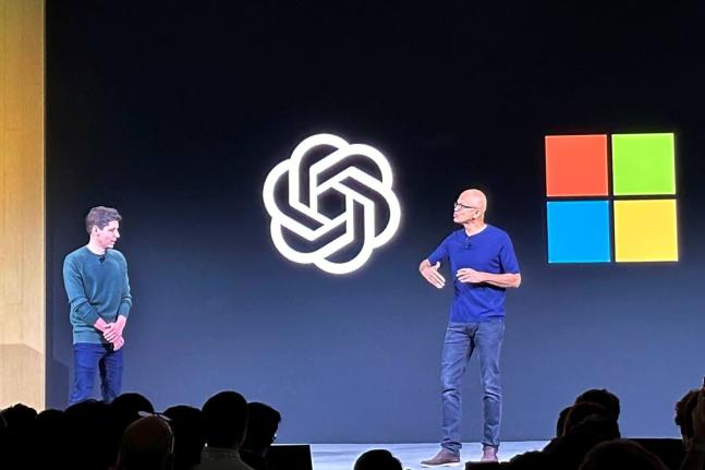 In this November 6, 2023 photo, OpenAI CEO Sam Altman, left, appears on stage with Microsoft CEO Satya Nadella at OpenAI’s first developer conference, in San Francisco.