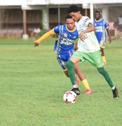 Frome Technical High School’s Raheem Dennison (right) tries to outrun Cambridge High School’s Kiron Malcolm during their Zone B ISSA daCosta Cup game at Jarrett Park on Saturday.