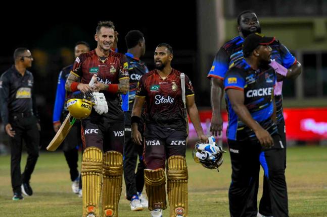 Trinbago Knight Riders’ Alex Hales (left) and Nicholas Pooran (second left) walk off the filed with players of the Antigua and Barbuda Falcons at the end of the Republic Bank Caribbean Premier League Eliminator at Guyana National Stadium in Providence, G