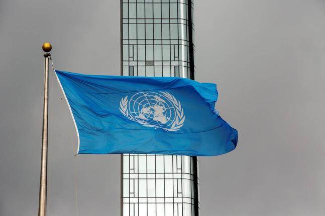 The UN flag flies on a stormy day at the United Nations during the United Nations General Assembly in September 2022.