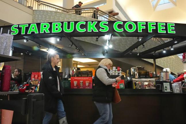 Shoppers at the Walden Galleria in Buffalo, NY, stop by the Starbucks kiosk on Saturday, November 30, 2024. (AP Photo/Gene J. Puskar, File)