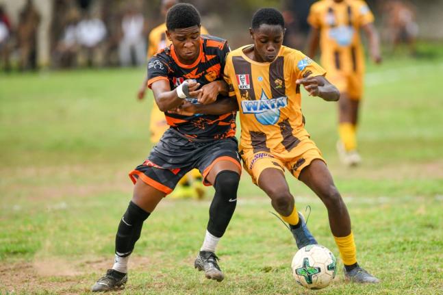 Ryan-Oniel Francis (left) of Tivoli High and  Marlon Anderson of Haile Selassie High battle for possession during yesterday’s ISSA Manning Cup match at Tivoli. The game ended in a 2-2 draw.
