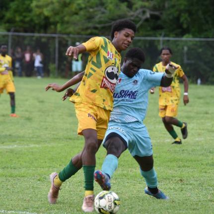 BB Coke’s Otis Powell (left) and Lacovia High School’s Rasheeve Francis battle for the ball during their first Zone E ISSA daCosta Cup match at the Lacovia High playing field September 27. The teams played to a second draw during a game at BB Coke yest