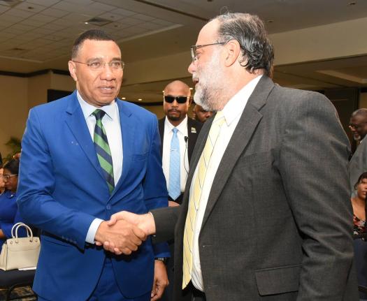 Prime Minister Dr Andrew Holness (left) and Mark Golding, leader of the Opposition, at the 45th Annual National Leadership Prayer Breakfast. 
