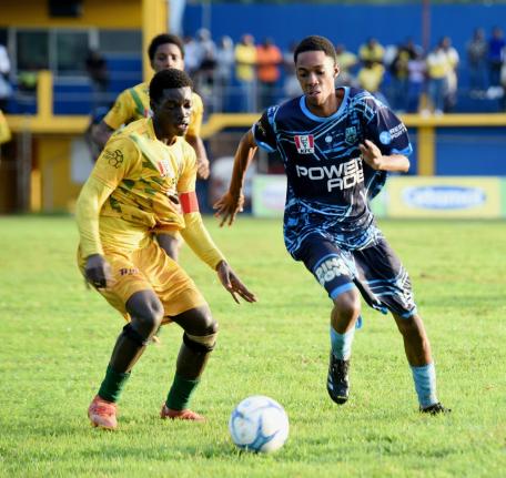 The Manning’s School’s Devardo Reid (right) tries to dribble past BB Coke captain, Yandria Morgan during thir Group 3 ISSA daCosta Cup second round game at the STETHS Sports Complex yesterday.