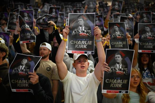 People hold posters of Charlie Kirk during a Turning Point USA rally at Utah State University, as a part of the organisation's push to memorialise Kirk, Tuesday, September 30, 2025, in Logan, Utah. (AP Photo/Alex Goodlett)