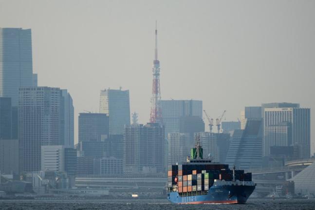 AP
Tokyo Tower is visible amid tall buildings as a container ship leaves a cargo terminal in Tokyo, April 2025. 