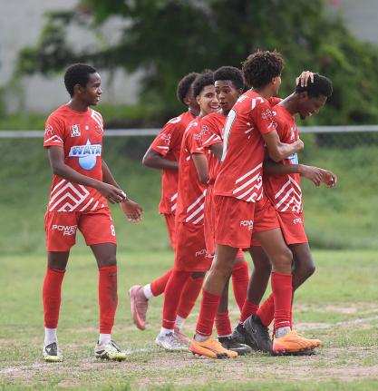 Members of the Campion College  team celebrate their second goal against Norman Manley High during their Manning Cup football match played at Campion College last Friday. Campion won 4-0.