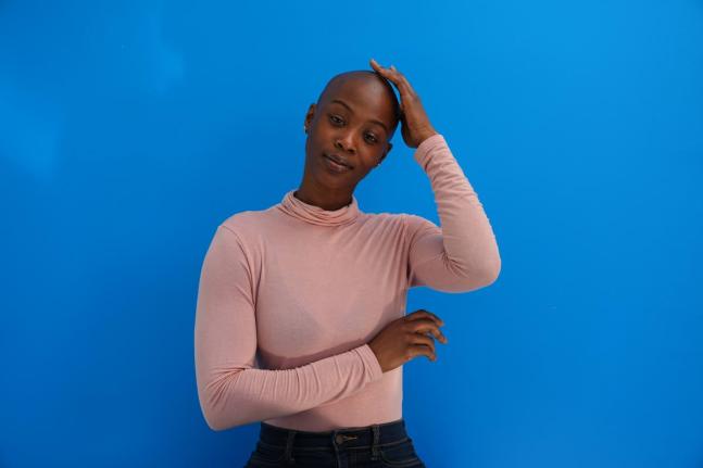 Aicha Soumaoro, a Philadelphia nurse and weekend mechanic, proudly embraces her bald look despite old-fashioned reactions from others.