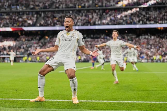 Real Madrid’s Kylian Mbappe reacts after scoring during a La Liga match between Real Madrid and Barcelona in Madrid, Spain, yesterday.