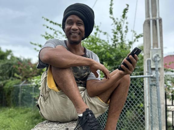 Dowan Hill, a farmer in Treasure Beach, St Elizabeth, on his wall listening to the news as he prepares for Hurricane Melissa, which is expected to make landfall on Tuesday, October 27, 2025.