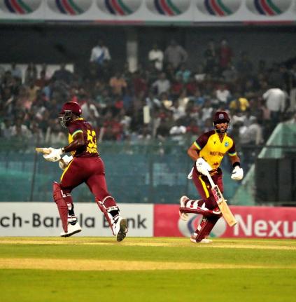 Former West Indies captain, Rovman Powell (left), runs a single with current captain, Shai Hope, on his way to an unbeaten 44 and an unbroken 83-run partnership to help his side claim the first T20I against Bangladesh at the Bir Sreshtho Flight Lieutenant 