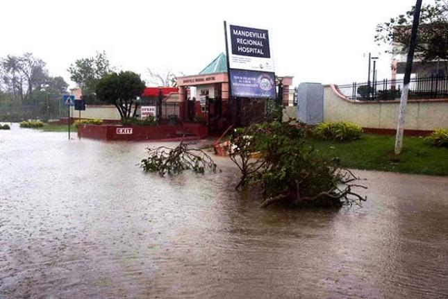 Floodwaters cover a section of Caledonia Avenue in Mandeville, blocking access to the entrance of the Mandeville Regional Hospital after Hurricane Melissa on Tuesday.