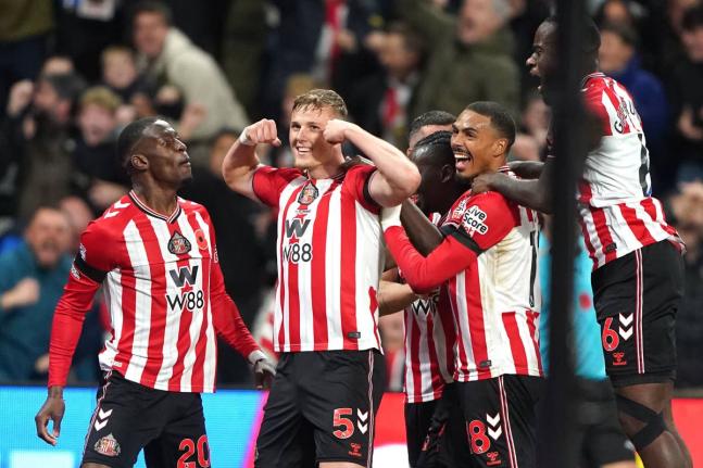 
Sunderland’s Daniel Ballard (second left) celebrates scoring his side’s first goal during the English Premier League football match against Arsenal in Sunderland, England, yesterday.